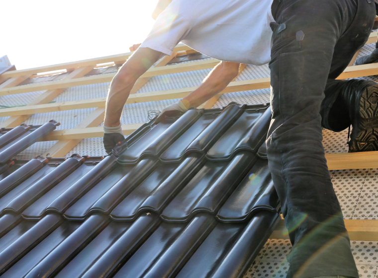 black metal roof being installed by roofer